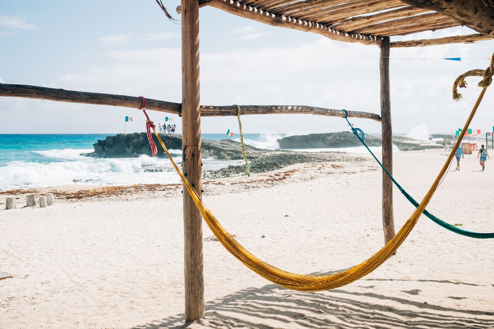 Hammock under a palm-thatch shade on a Caribbean beach, the simple pleasure of cheap cruises