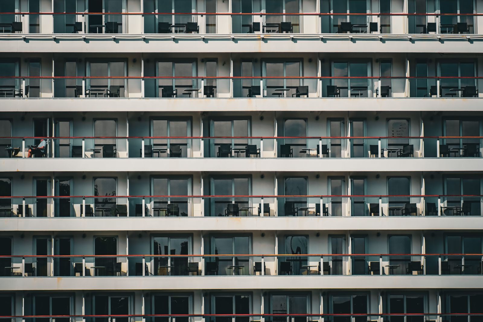 Rows of balcony cabins along the side of a large cruise ship